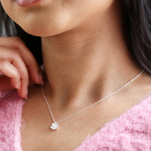 Close up of Estella Bartlett Silver Pearl Buttercup Necklace on model