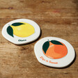 Two Personalised Fruit Organic Shape Coasters on Wooden Table