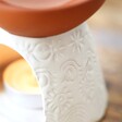 Close Up of Stamped White and Terracotta Oil Burner