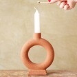 Model Lighting Candle in Terracotta Candlestick Holder