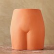 Front of Terracotta Speckled Bum Vase on Wooden Table