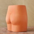 Terracotta Speckled Bum Vase on Wooden Table