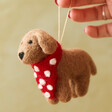 Model holding Felt Pip the Dog Hanging Decoration by the string