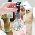 Stainless Steel All in One Bottle Pourer in Use in a bottle of white wine
