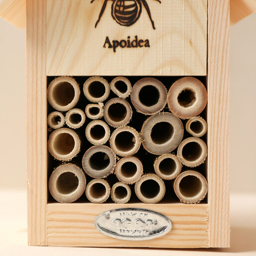 Close Up of Hollowed Out Bamboo in Wooden Bee House 