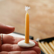 Model holding candle and holder from Box of 12 Mini Beeswax Bath Time Candles