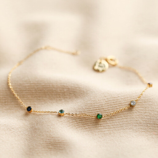 Gold Stainless Steel Rainbow Crystals Bracelet on fabric background