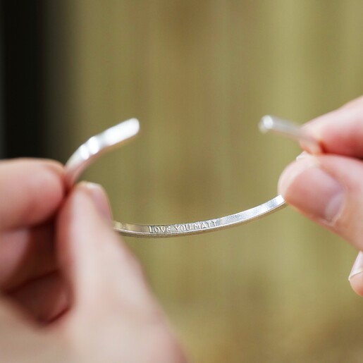 Model Holding Bracelet Lisa Angel Personalised Men's Brushed Bar Bangle in Black with Model