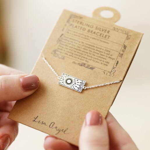Model Holding Silver The Sun Tarot Card Bracelet on Card