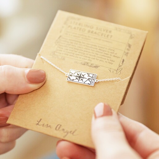 Model Holding Silver The World Tarot Card Bracelet on Card