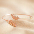 Rose Gold Feather Bangle on fabric