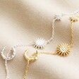 Sun and Moon Chain Bracelet in Silver alongside gold version on neutral fabric
