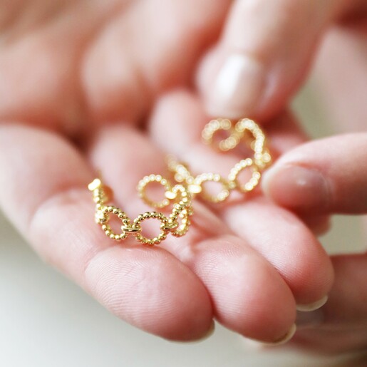Model Holding Beaded Chain Style Hoop Earrings
