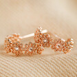 Crystal Daisy Hoop Earrings in Rose Gold on fabric