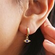 Crystal Eye Huggie Hoop Earrings in Gold On Model
