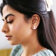 Model Wearing Delicate Double Half Pearl Stud Earrings in Silver