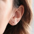 Close Up of Model Wearing Irregular Crystal Heart Stud Earrings in Rose Gold