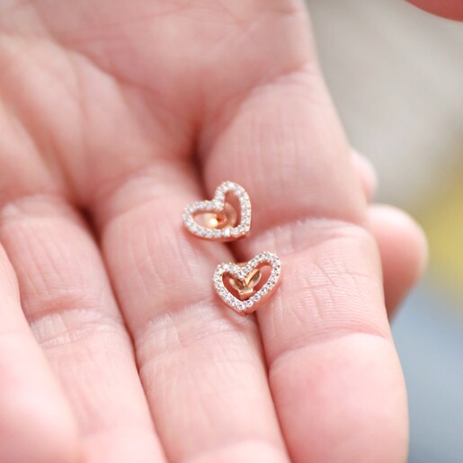 Model Holding Irregular Crystal Heart Stud Earrings in Rose Gold