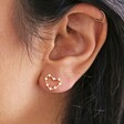 close up of models ear wearing Mismatched Crystal Heart outline stud Earrings