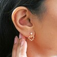 close up of model wearing Mismatched Crystal Heart drop stud Earrings