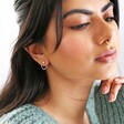 model wearing Mismatched Crystal Heart Earrings in Rose Gold