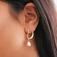 Close Up of Organic Circle Pearl Drop Earrings in Gold on Model