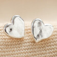 Small Hammered Heart Stud Earrings in Silver on fabric background