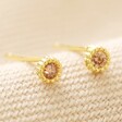 Topaz Sterling Silver Birthstone Stud Earrings in Gold on Beige Fabric