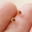 Model Holding Garnet Sterling Silver Birthstone Stud Earrings in Gold