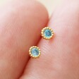 Model Holding Aquamarine Sterling Silver Birthstone Stud Earrings in Gold