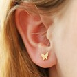 Model Wearing Tiny Butterfly Stud Earrings in Gold