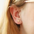 Tiny Butterfly Stud Earrings in Gold on Model