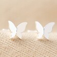 Tiny Butterfly Stud Earrings in Silver on Fabric