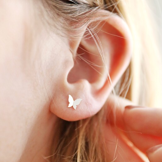 Tiny Butterfly Stud Earrings in Silver on Model