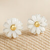 Tiny Enamel Daisy Stud Earrings on Beige Fabric