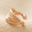 Tiny Rose Gold Sterling Silver Feather Ear Cuff on Fabric Background