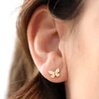 Model Wearing White Enamel Butterfly Stud Earrings in Gold
