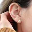 White Enamel Butterfly Stud Earrings in Gold on Model