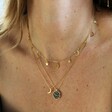 Model wearing Day and Night Reversible Necklace in Gold layered with other necklaces