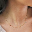 close up of model wearing Gold Stainless Steel Rainbow Crystals Necklace