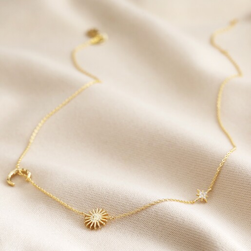 Full Length of Necklace Sun and Moon Chain Necklace in Gold on Beige Fabric