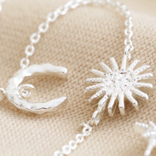 Close Up of Sun and Moon Chain Necklace in Silver Close Up of Sun and Moon Chain Necklace in Silver on Beige Fabric