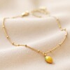 Enamel Lemon Charm Anklet in Gold on Beige Fabric