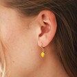 Model Wearing Enamel Lemon Huggie Hoop Earrings in Gold