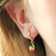 Enamel Strawberry Huggie Hoop Earrings in Gold on Model