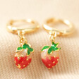 Enamel Strawberry Huggie Hoop Earrings in Gold on Beige Fabric