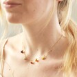 Model Wearing Enamel Fruit Charm Necklace in Gold