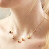 Close Up of Model Wearing Enamel Fruit Charm Necklace in Gold
