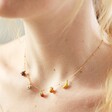 Close Up of Model Wearing Enamel Fruit Charm Necklace in Gold