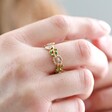 Close Up of Enamel Flower Ring in Gold on Model